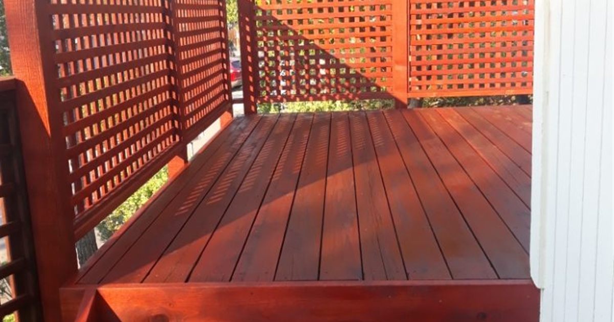 Freshly stained western red cedar deck in Seattle, the upkeep side of the cedar vs composite decking decision