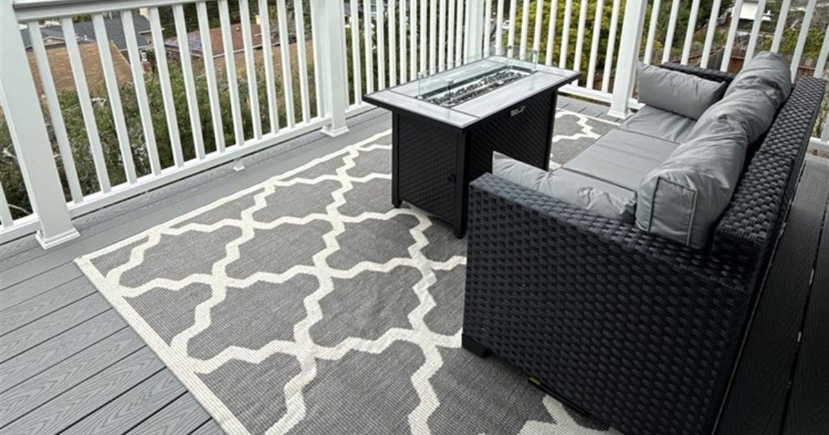 Gray PVC deck with white railing on an elevated Seattle site, where the PVC vs composite decking choice tips toward PVC